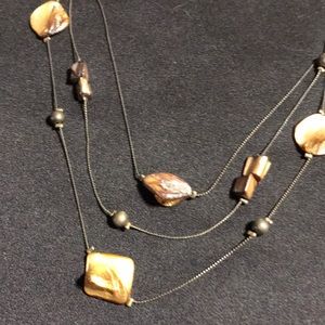 Women’s bronze colored necklace with stones.